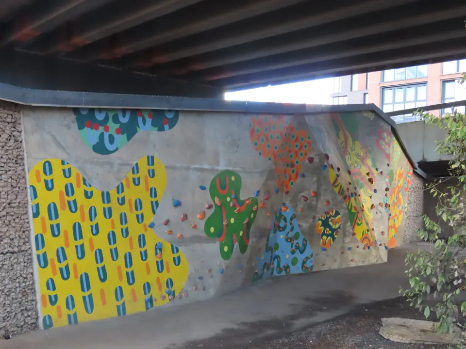 Holds across yellow and green painted panels at the far end of the wall