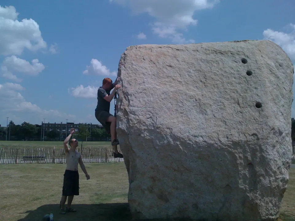 Climber on the granite boulder in Shoreditch Park