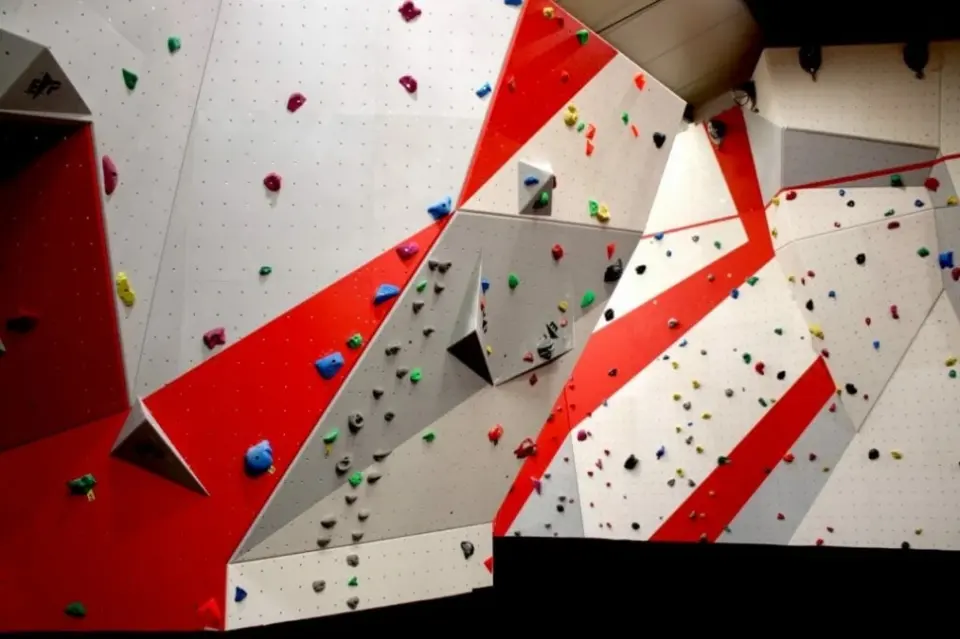 Long bouldering wall with grey and red sections