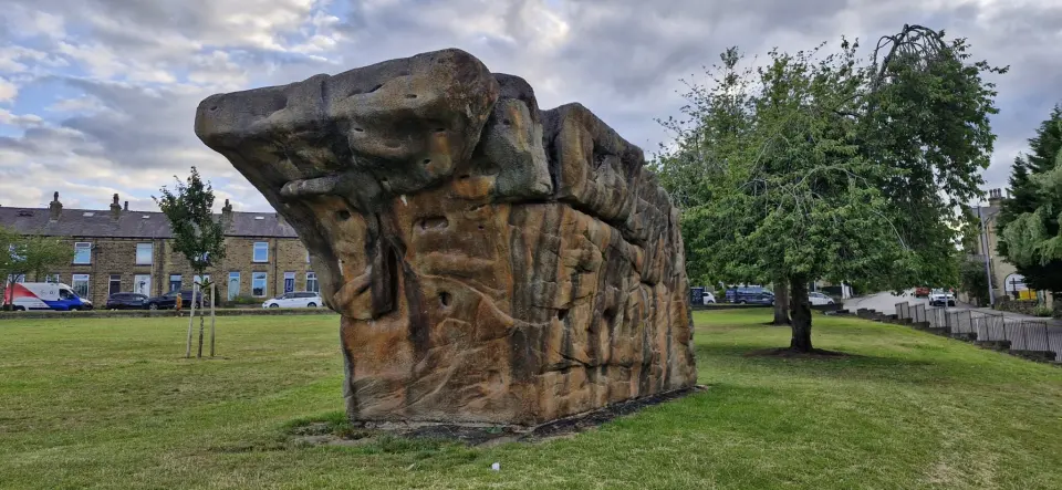 The sculpted concrete boulder on the grass of Crow Lane Recreation Ground