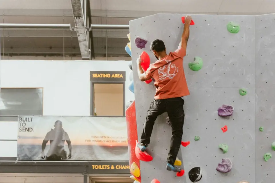 Climber on a grey wall near the seating area