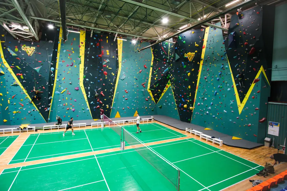 Tall blue climbing walls around the badminton court at Europe Lyulin