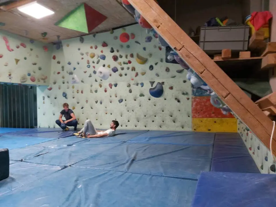 Bouldering walls, blue landing mats and wooden stairs inside SPK Paklenica in Zadar