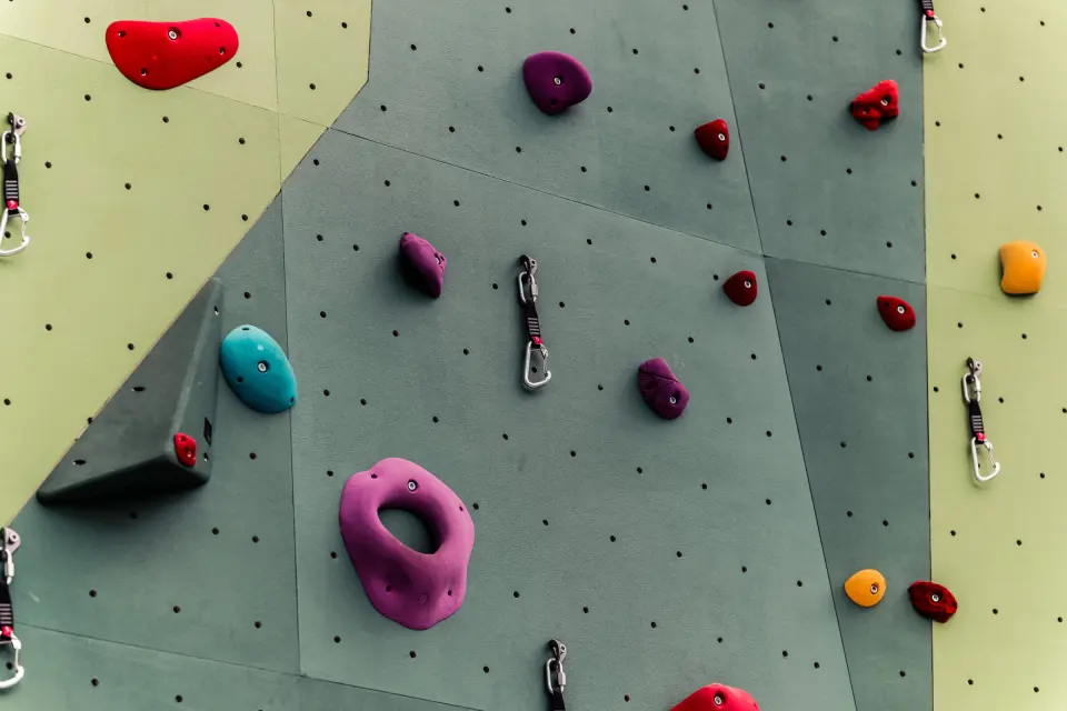 Coloured holds and fixed protection on the Vema climbing wall