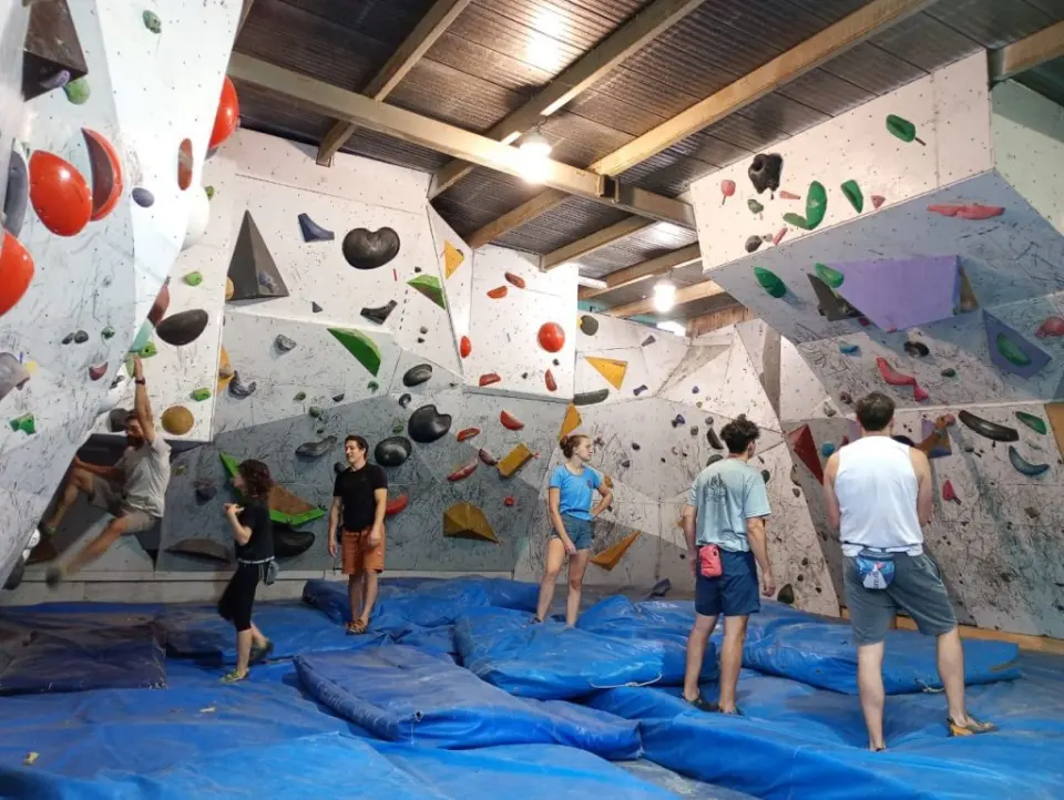 Bouldering walls and blue landing mats at GRAM La Casona
