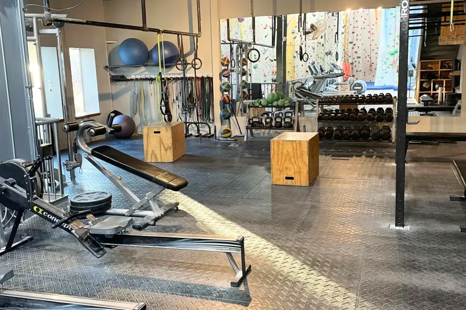 Fitness area with racks, dumbbells and plyo boxes
