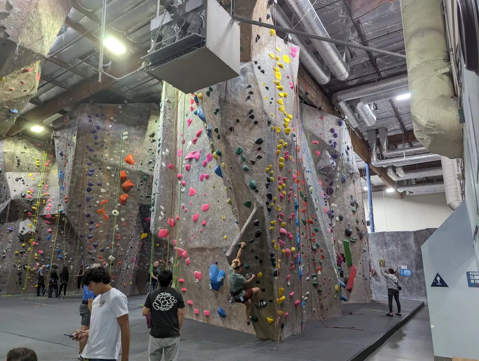 Roped walls and the tall prow with climbers on top rope