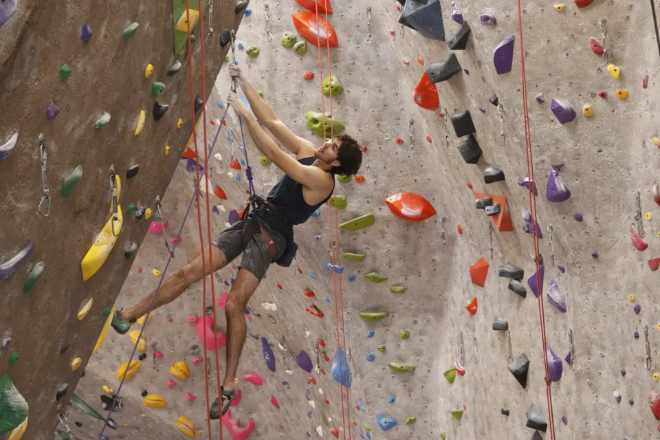 Climber leading a steep route on the roped walls