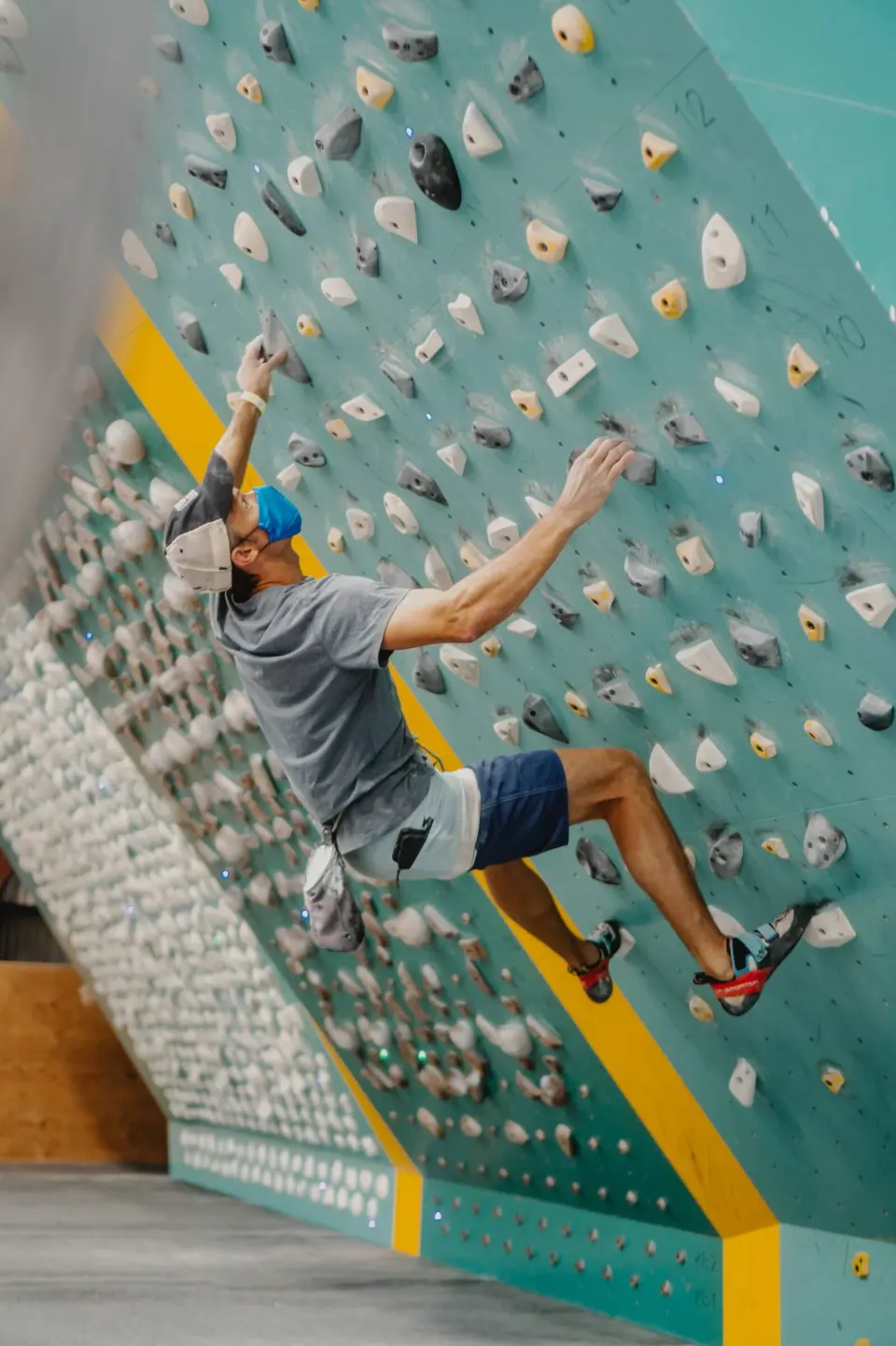 Climber reaching across the MoonBoard