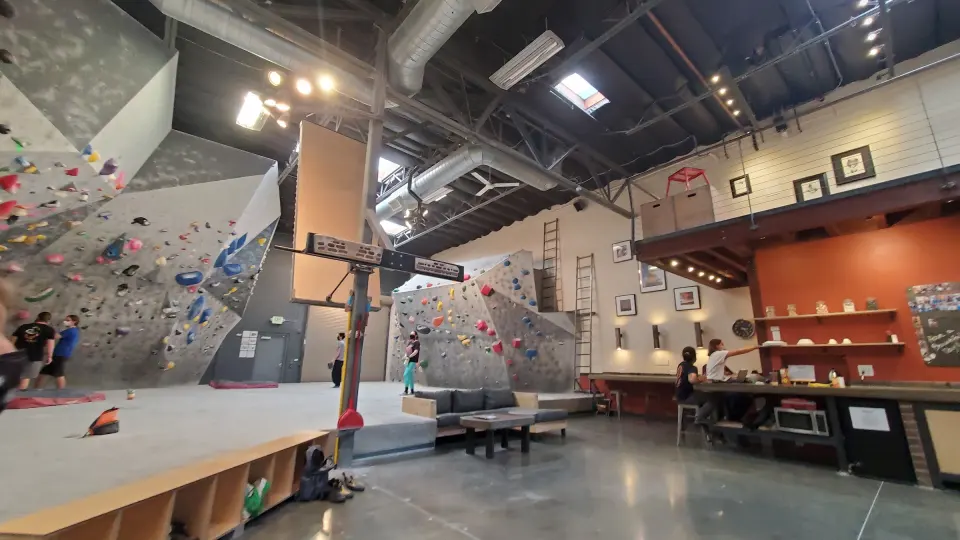 Wide view of the gym with the walls, front counter and mezzanine