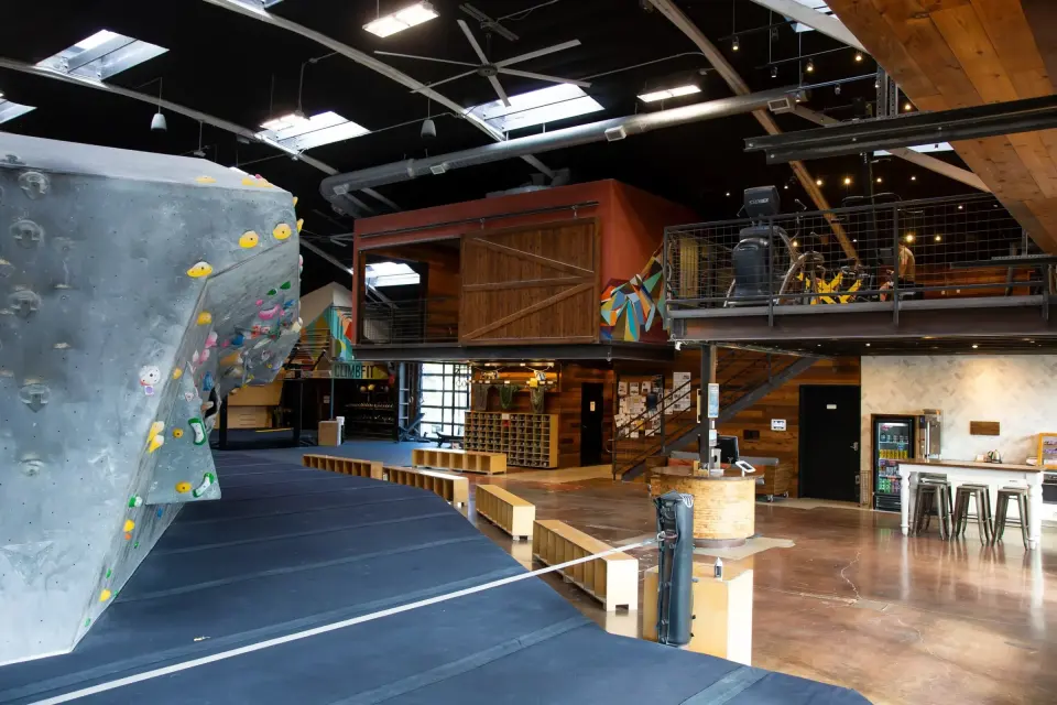 Boulder and matted floor in front of the lounge, front desk and mezzanine