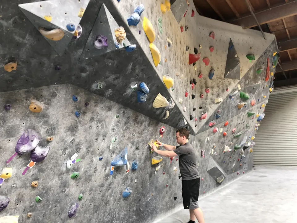 Climber starting a problem under an overhanging prow