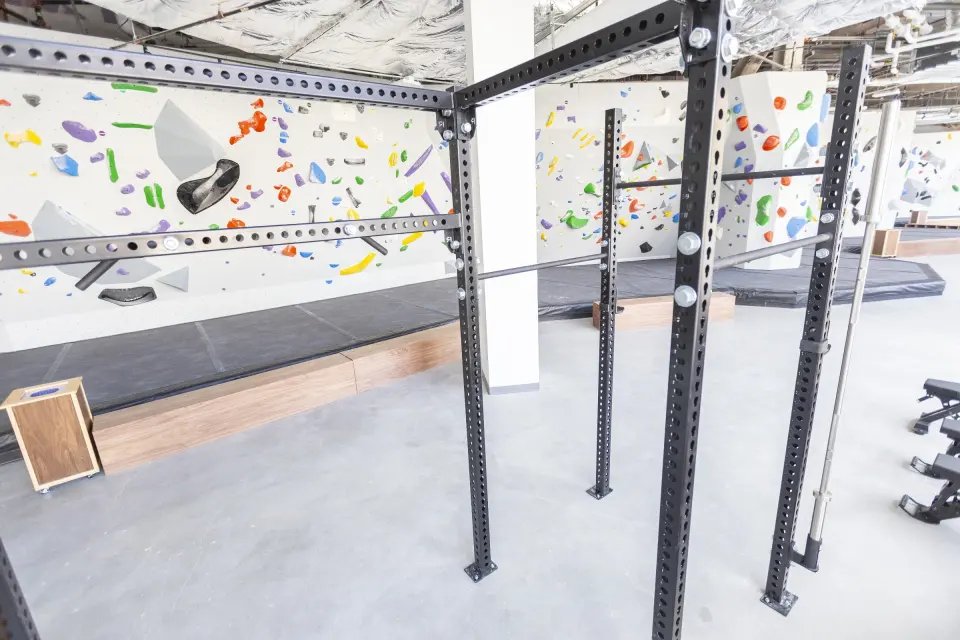 Pull-up rig and weights in front of the bouldering walls