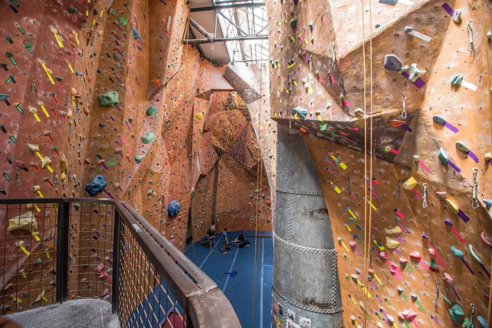 Tall roped walls around the old riveted steel stack, seen from the stairs