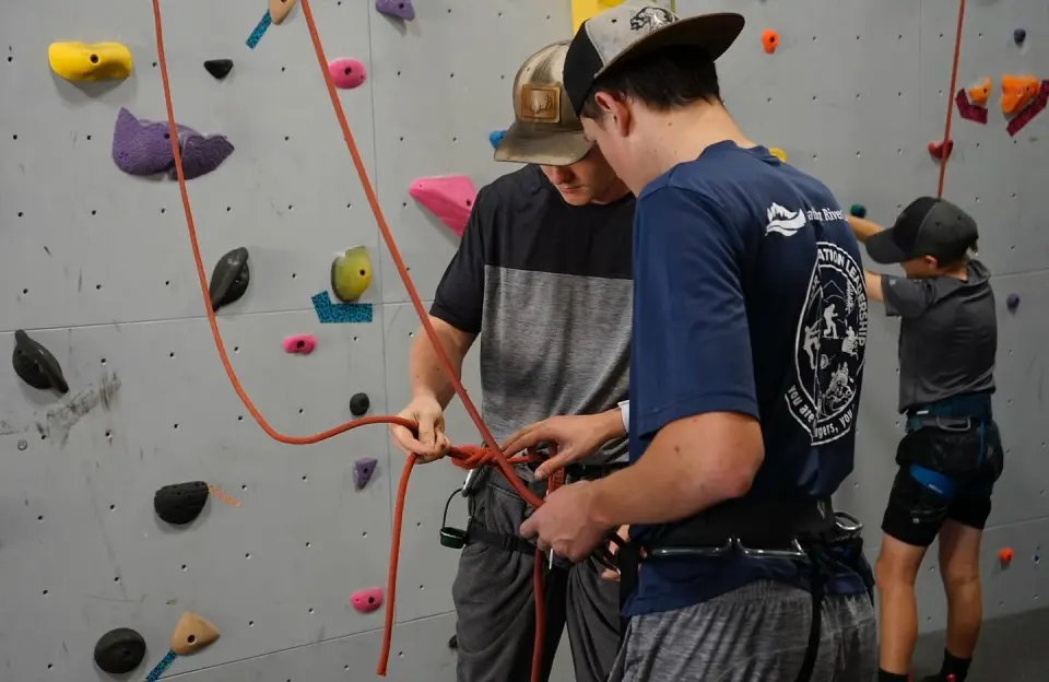 Climbers tying in at the grey top-rope wall