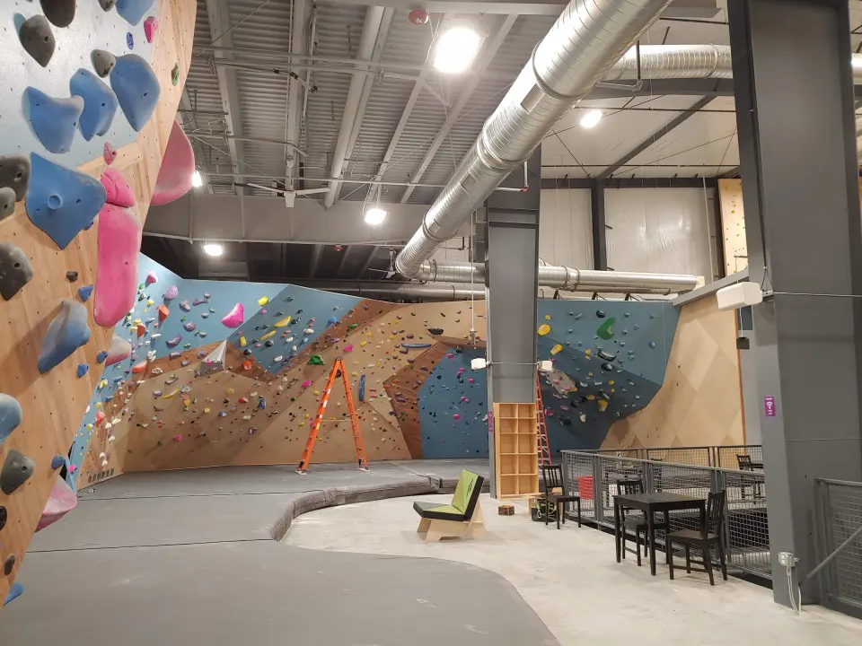 Bouldering walls and seating area under the high ceiling