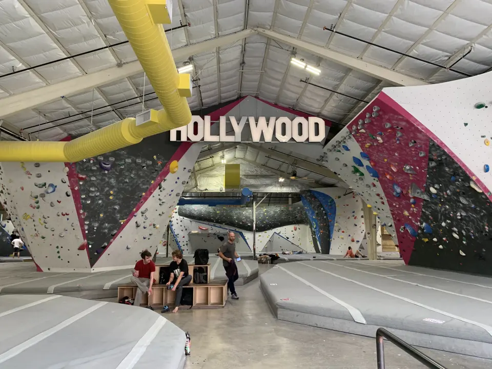 HOLLYWOOD sign above the bouldering walls and a yellow duct
