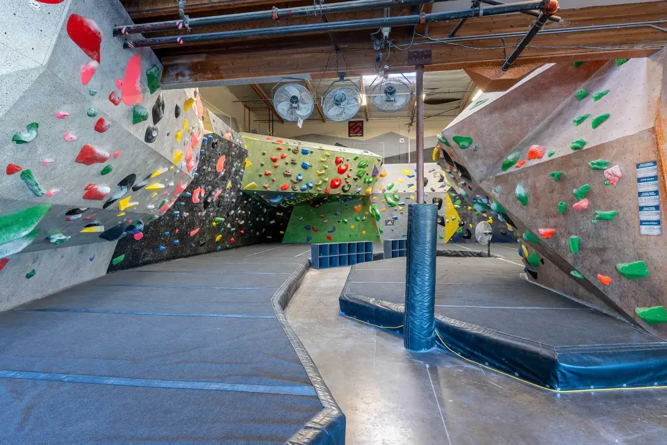 Bouldering walls around a padded central floor