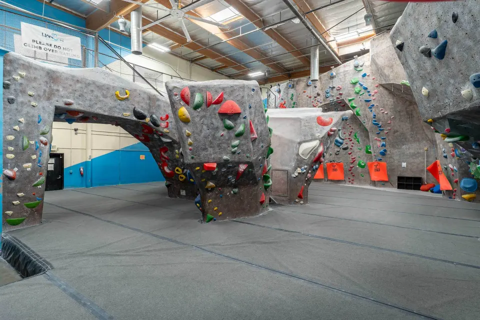 Bouldering walls in front of the auto-belay wall