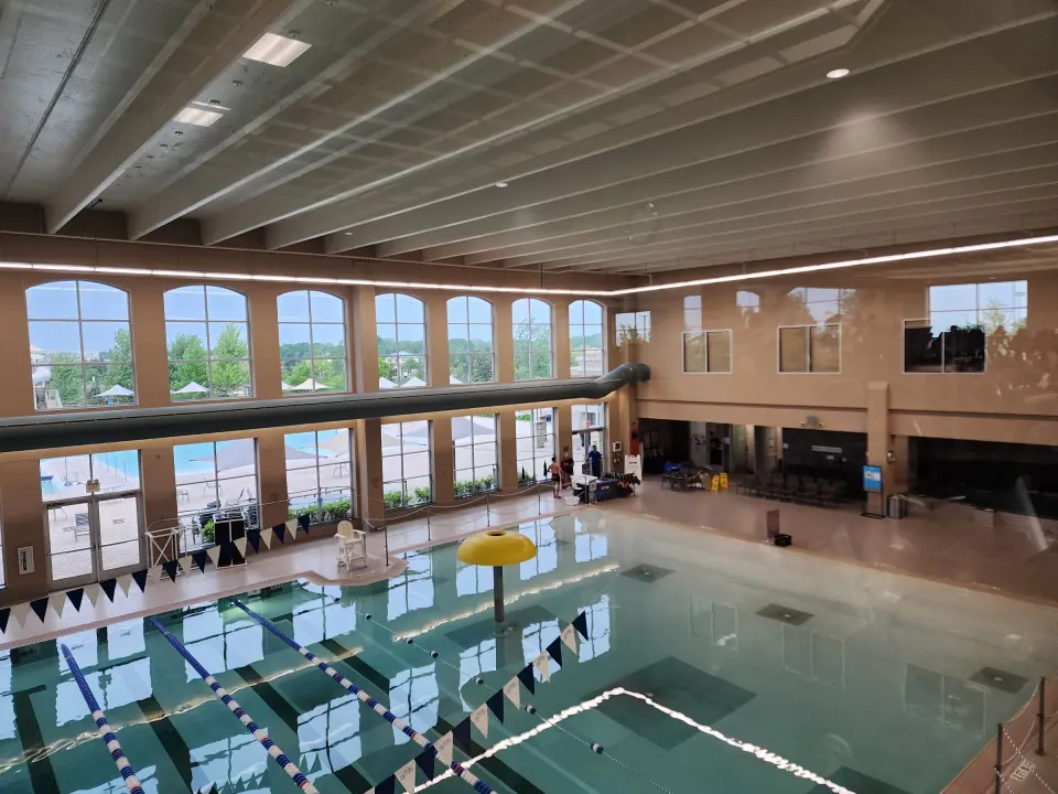 Indoor lap pool beneath tall arched windows