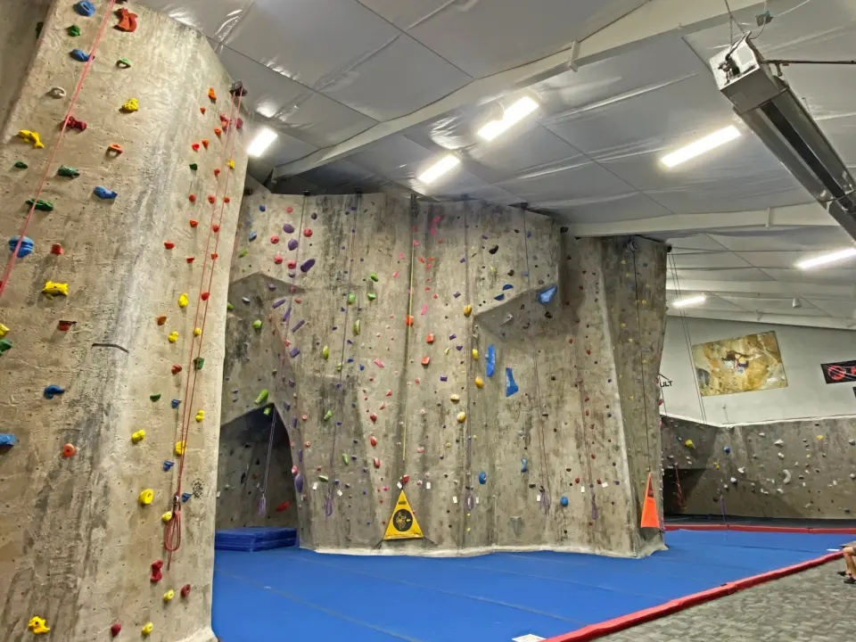 Top-rope walls with an archway above blue matting