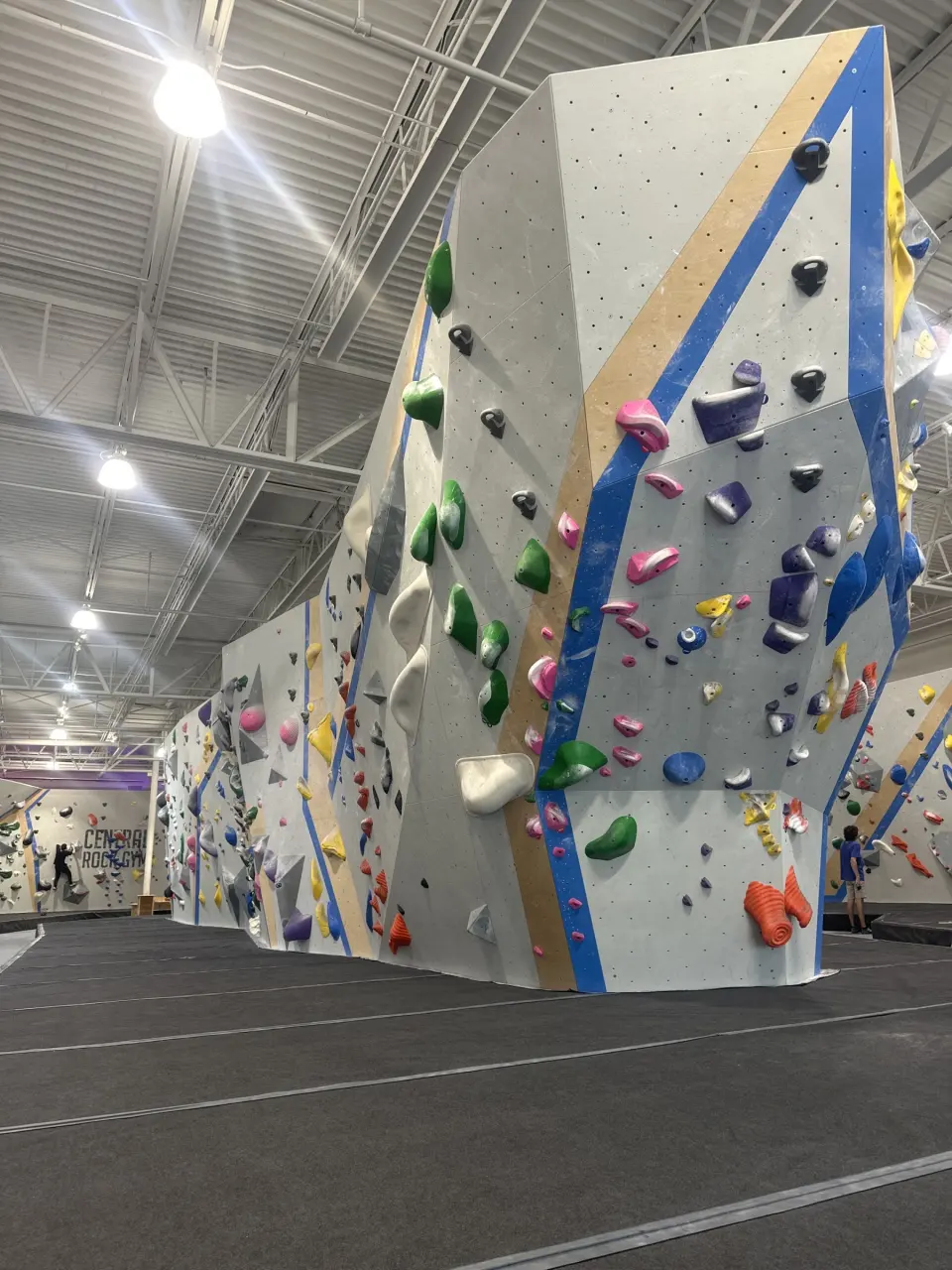 Tall bouldering tower under the warehouse roof