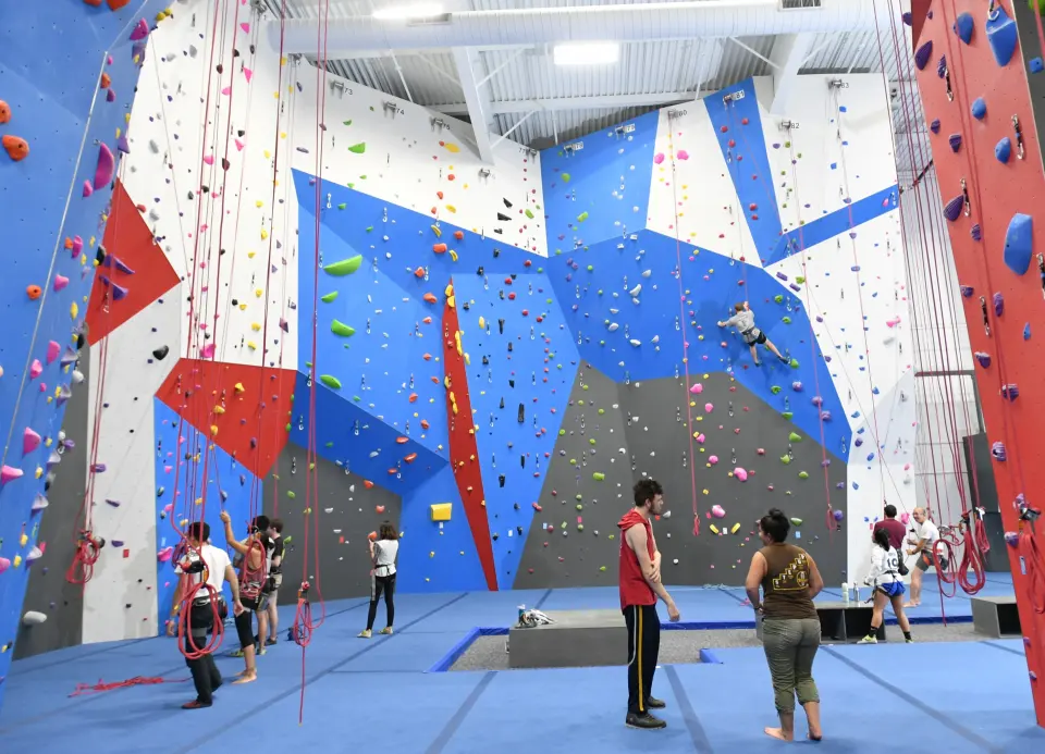 Tall white, blue and red roped walls above blue matting