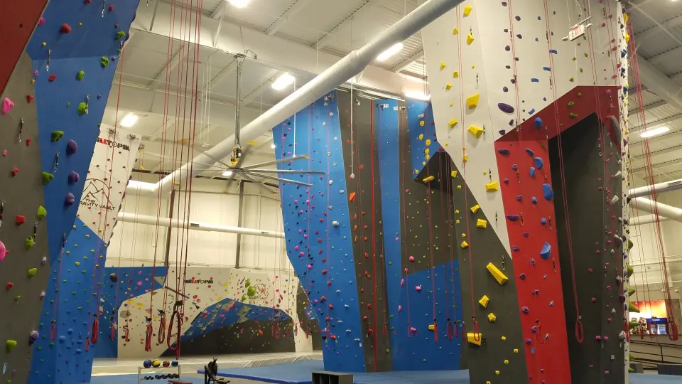 Roped walls and the bouldering area under a high ceiling