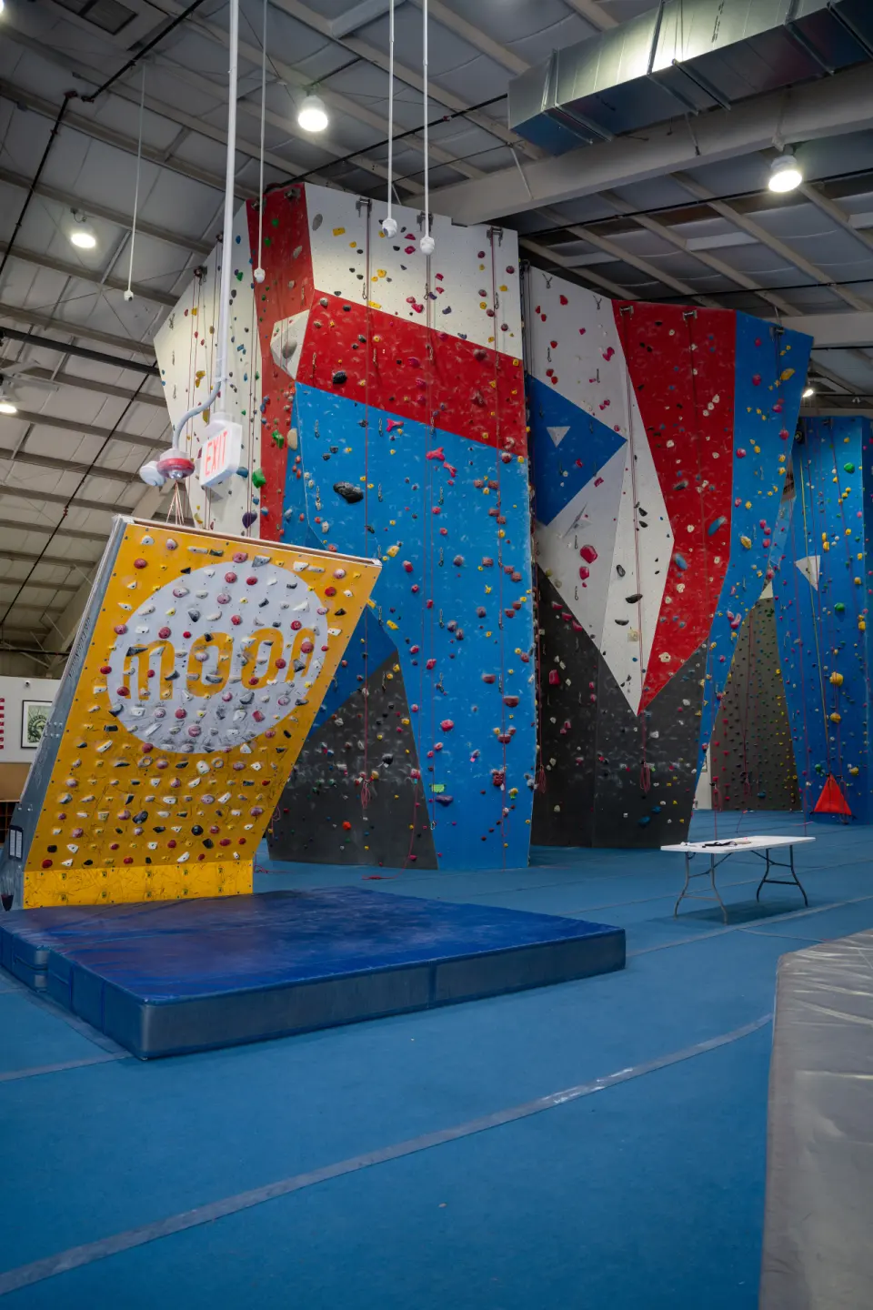 Yellow MoonBoard in front of the red, white and blue roped walls