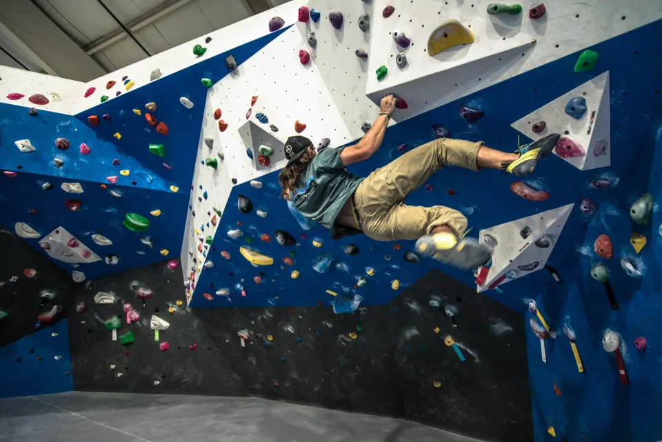 Climber on the overhanging section of the bouldering wall
