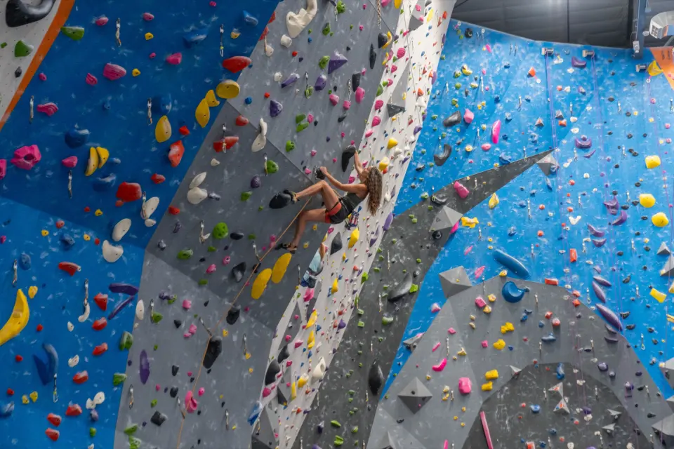 Climber high on a steep roped wall