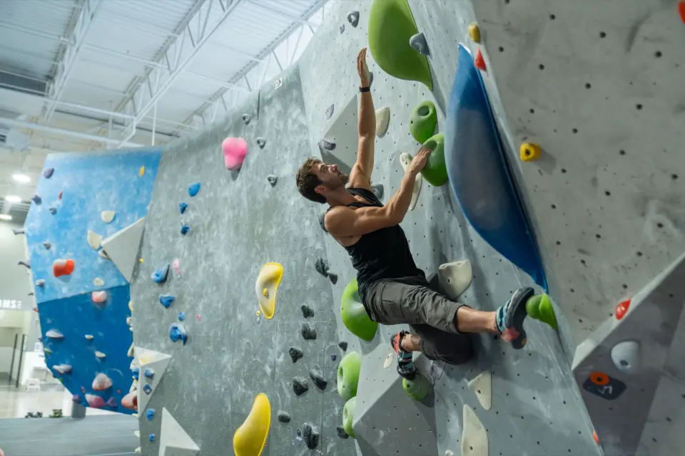 Climber on an overhanging boulder