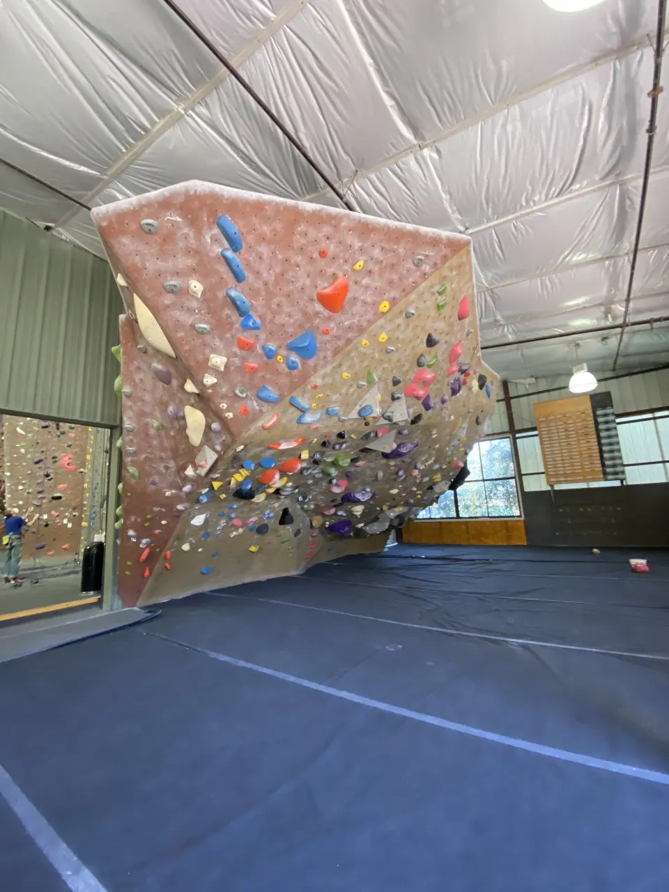 Overhanging freestanding boulder above blue matting
