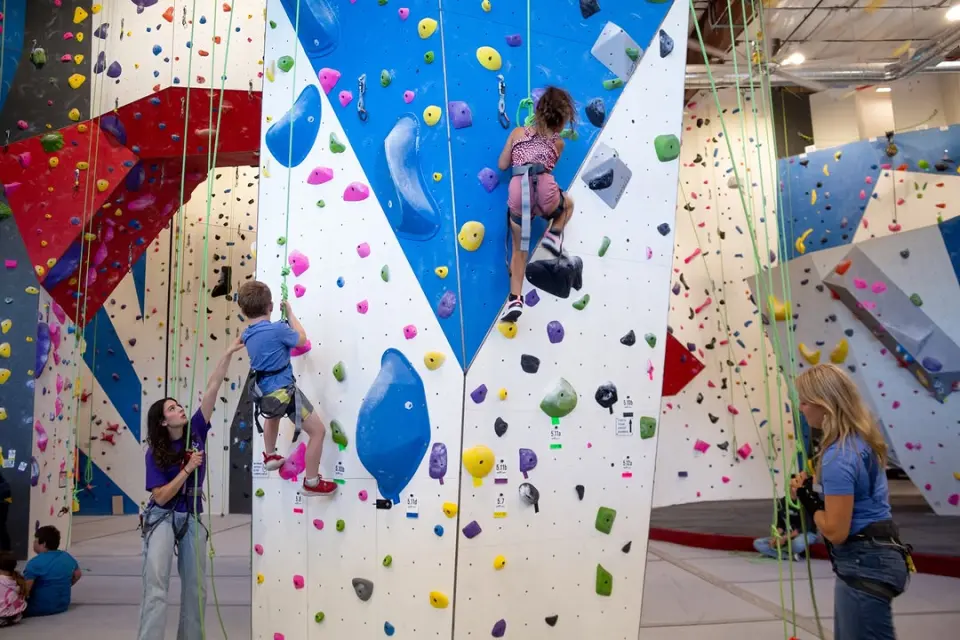 Climbers on the white, blue and red rope walls