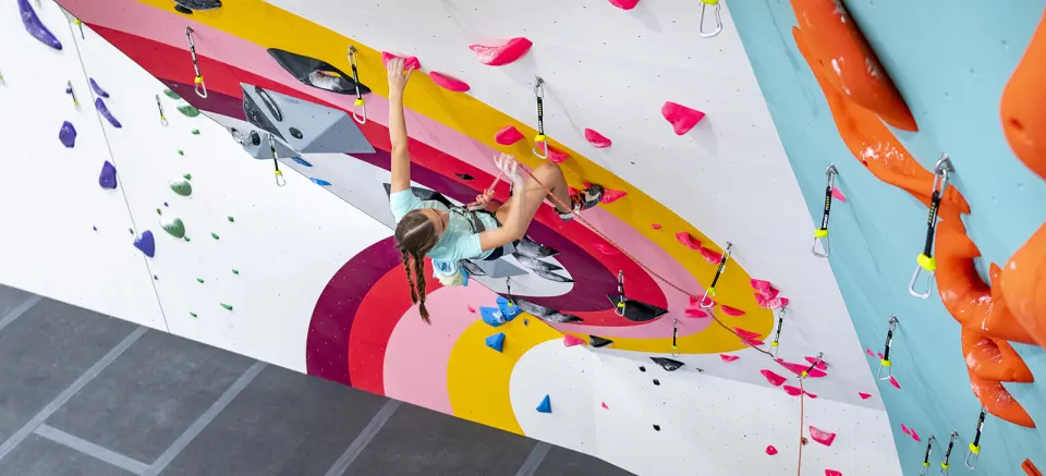 Lead climber on the rainbow-striped overhang