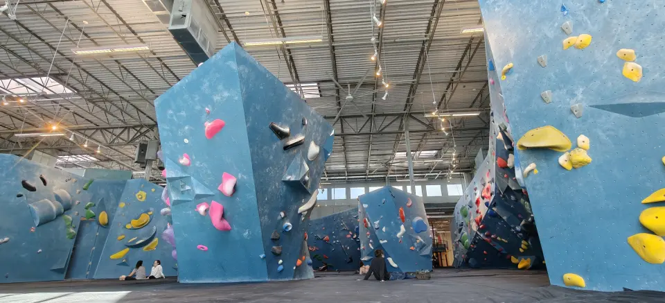 Freestanding blue boulders under the skylit roof