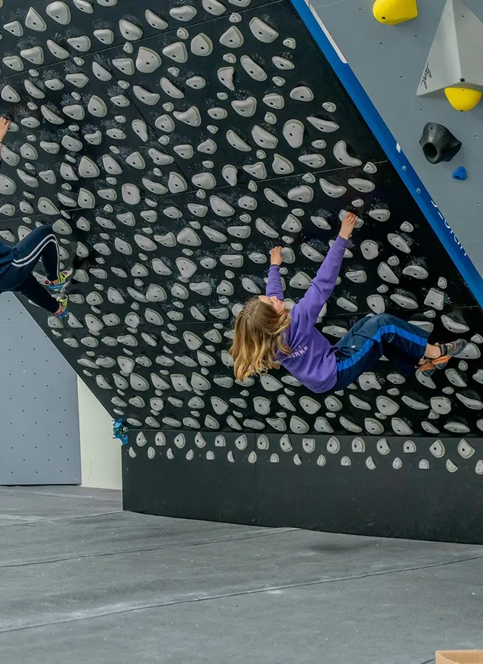 Climber on the 45-degree spray wall