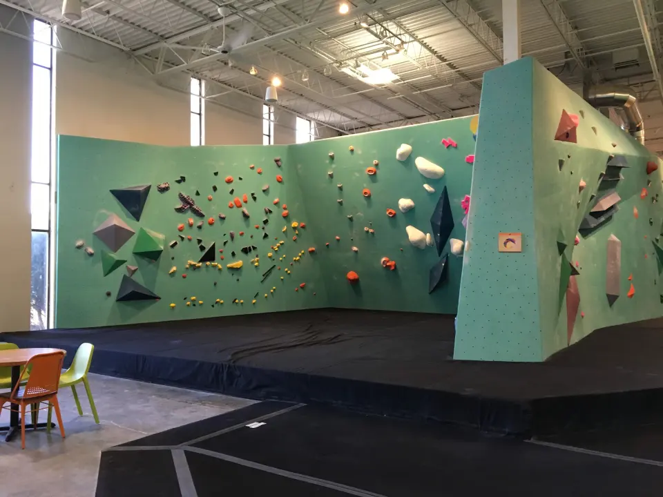 Long bouldering wall beside the seating area