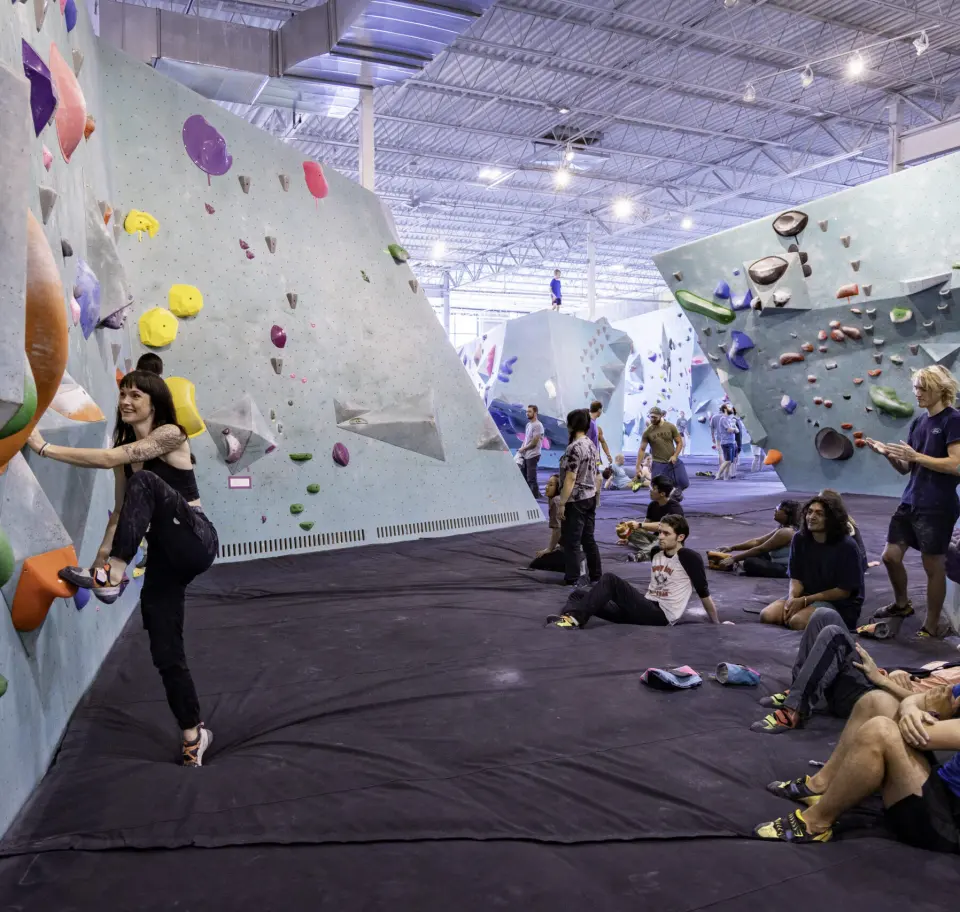 Climbers resting on the mats below the main bouldering walls