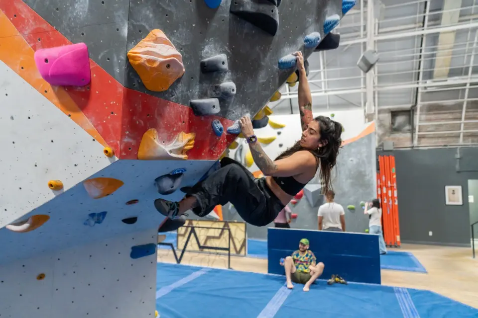 Climber on a steep overhanging boulder