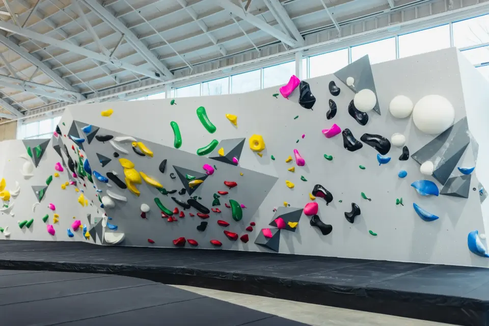 The long main bouldering wall under the skylit roof