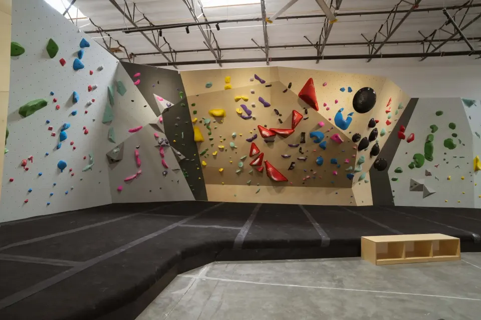 Bouldering wall with yellow and red problems