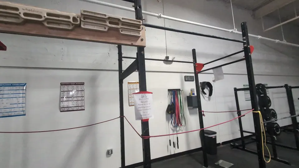 Squat racks and weight plates in the fitness area