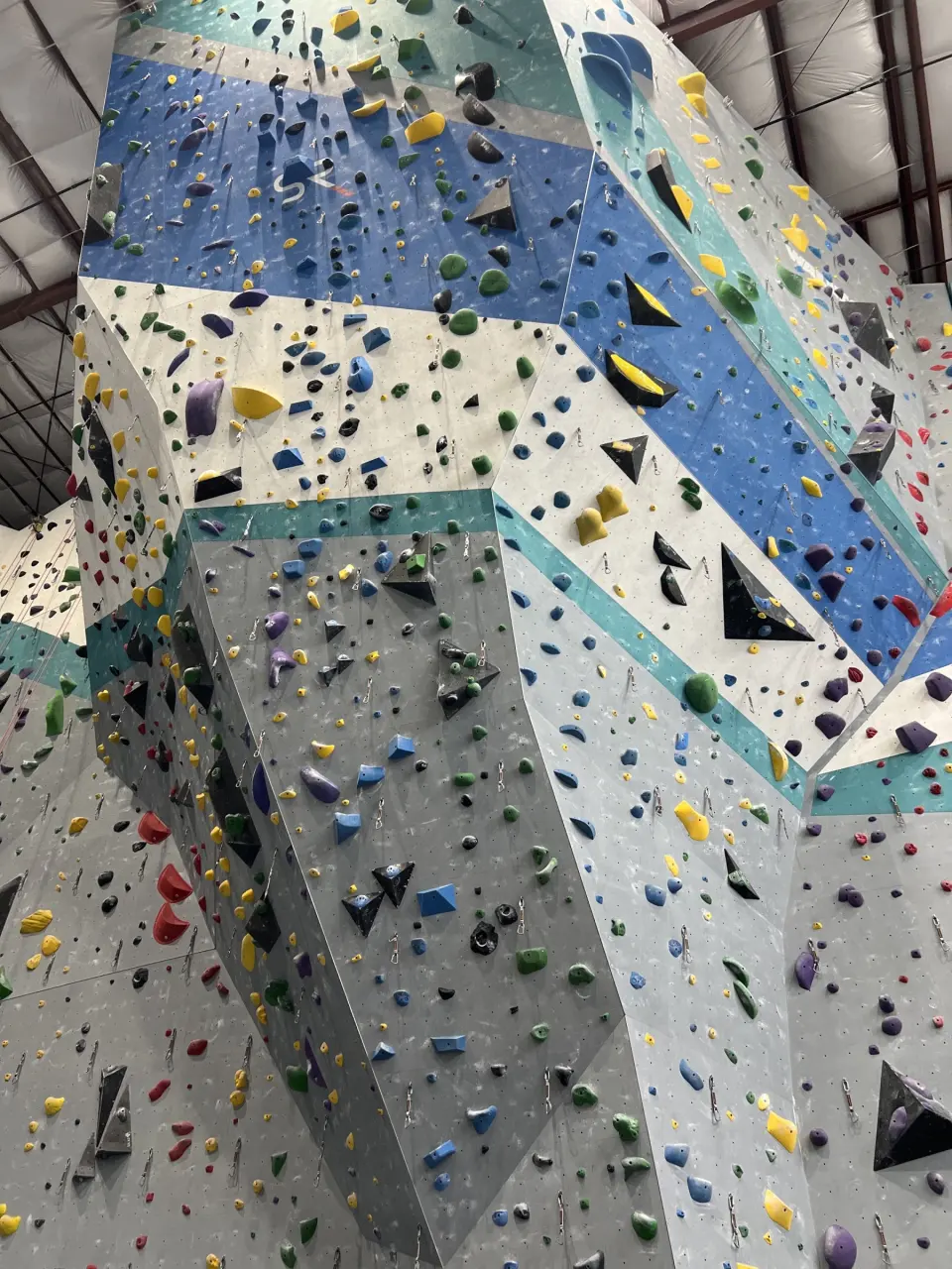 Looking up the tall roped wall with its blue and teal bands