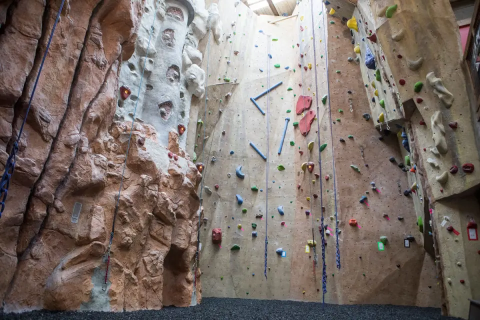 Rope walls beside the sculpted rock face and lighthouse tower