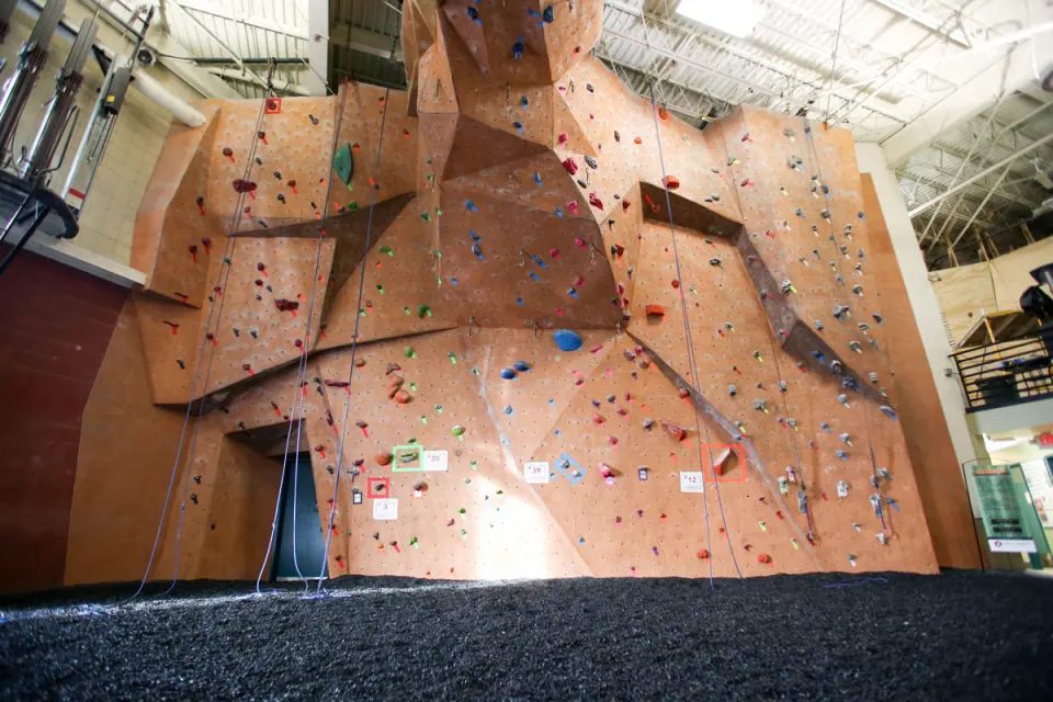 Tall orange rope wall with angled features and quickdraws