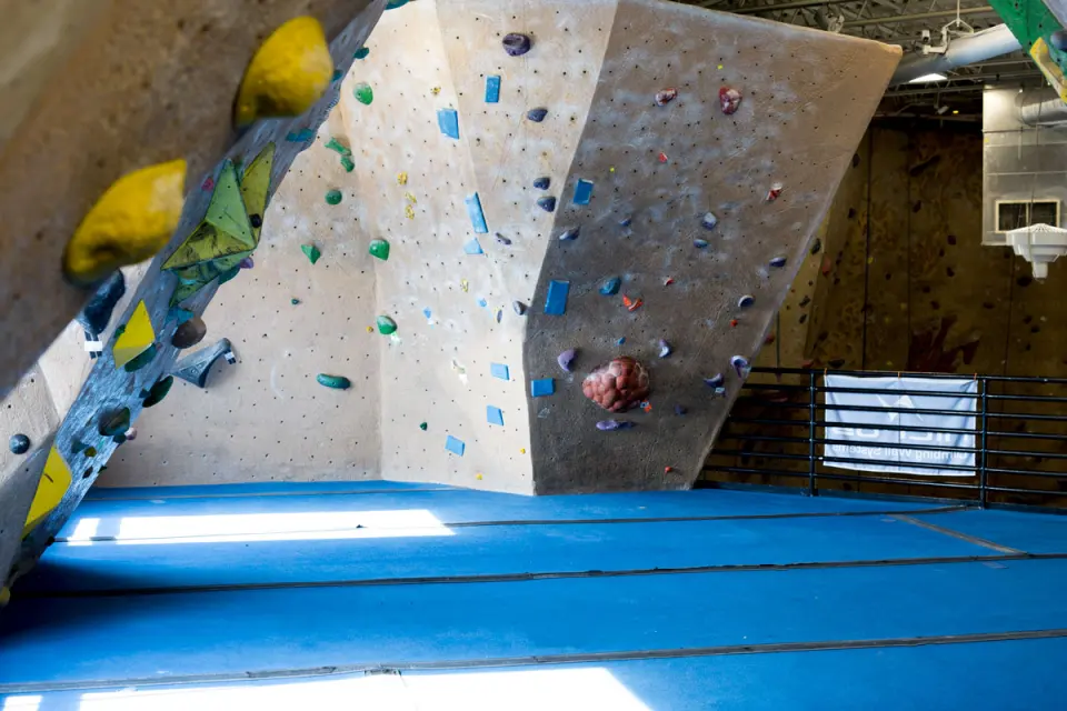 Bouldering walls with large volumes above blue matting