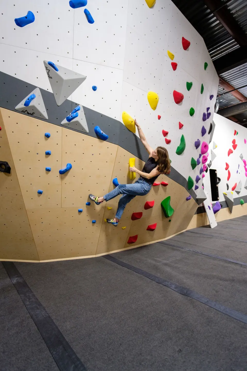 Climber on a vertical bouldering wall