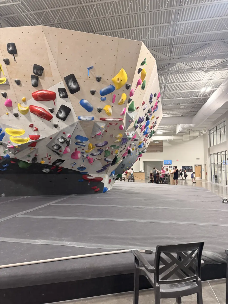 Steep bouldering overhang covered in colourful holds