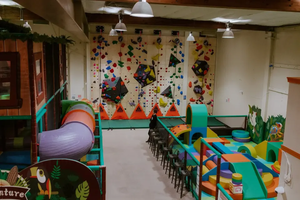 Adventure Center play structure in front of the climbing wall